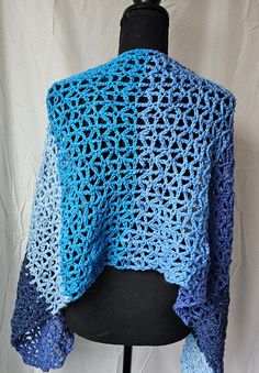 This is a light weight wrap which can also be worn as an oversized scarf.  It is hand-crocheted and the pattern is open, which makes this lightweight.  The yarn is very soft but durable, and this will keep you warm and look gorgeous. Approx. 52" long and 16" wide Made with Caron Cakes Yarn, 80% Acrylic, 20% Wool. Machine wash/dry Crochet Lace Shawl For Winter, One Size, Crochet Lace Shawl One Size For Winter, One Size Crochet Lace Shawl For Winter, Winter Crochet Lace Shawl One Size, Handmade Blue Casual Scarves, Casual Handmade Blue Scarves, Blue Crochet Shawl One Size, Beach Crochet Shawl One Size, Blue Crochet Yarn Shawl