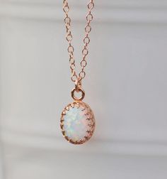 "A sweet new necklace using 14K rose gold and opal. The opal is oval shaped and white in color. It has broad rainbow flashes and excellent fire. Opal is hand set into a premium, rose gold plated crown setting. It hangs from 14K rose gold filled chain, in your length of choice. Opal measures 10mm tall (just under 1/2\") while entire pendant measures 3/8\" long. Please choose desired chain length at checkout. Please see all of my rose gold opal pieces here: https://www.etsy.com/shop/hangingbyathre Gold Opal Round Necklace, Gold Pink Opal Necklace For Gifting, Unique Opal Round Pendant Necklace, Opal Pendant Rose Gold Necklace, Pink Opal Gemstone Pendant Necklace, Opal Pendant Necklace, Opal Pendants, Opal Necklace, White Opal