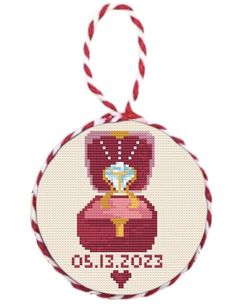 a cross stitch ornament with a princess tiara on it's chest