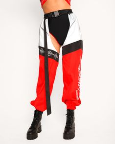 Feel the lightning power coursing through your veins as you slip into the SLANDER x iHR Electric Edge Reflective Chaps! These rave bottoms feature a tricolor construction and the Slander logo along the thighs. This item is excluded from the sale. Adjustable belt Stretch Red Color Block Bottoms, White Training Bottoms With Elastic Side Panels, Sporty Contrast Color Pants For Streetwear, Sporty Streetwear Pants With Contrast Color, Black Color Block Bottoms For Streetwear, Black Gym Bottoms With Reflective Details, Black Activewear With Contrast Color For Training, Sporty Bottoms With Contrast Color For Sports, Fitted Red Color Block Bottoms