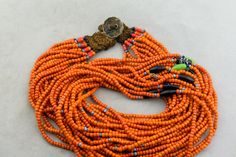 "A vintage Naga Konyak multi strand bead necklace made in Nagaland in the first half of the 20th century. In good condition - one strand has missing focal bead and was tied off a long time ago - can be seen in the photos. Includes an old silver coin made into a button, for a button and loop closure. 28\" long 15 strands 15x7mm center bead" Vintage Multi-strand Colorful Beaded Necklaces, Vintage Multi-strand Beaded Necklaces With Colorful Beads, Vintage Multi-strand Beaded Necklace With Colorful Beads, Vintage Multi-strand Beaded Necklace With Polished Beads, Unique Multi-strand Polished Beads, Handmade Vintage Multi-strand Beads, Traditional Multi-strand Polished Beads, Traditional Multi-strand Beads For Jewelry Making, Unique Multi-strand Hand-strung Beads