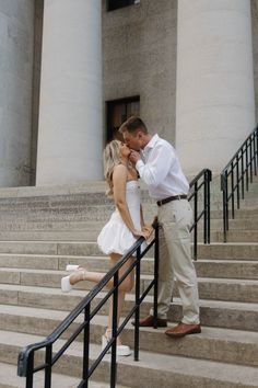 a man and woman kissing on the steps