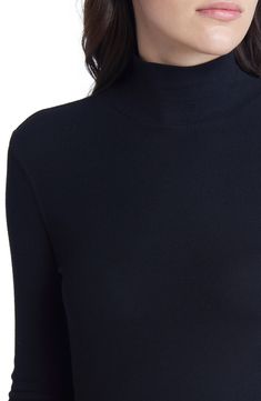 Cut from soft, microribbed fabric, this closet-staple mock-neck top looks fantastic as part of your cool-weather layering strategy or starring on its own. 23 1/2" Length ( size medium) Mock neck Long sleeves 96% modal, 4% Elastane Machine wash, tumble dry Made in Peru Classic Ribbed Turtleneck Top, Ribbed Turtleneck Top For Work, Mock Neck Top With Ribbed Neckline, Mock Neck Top With Ribbed Neckline For Layering, Mock Neck Top With Ribbed High Neckline For Layering, Versatile Ribbed Turtleneck Tops, Ribbed High Neck Top For Work, Sleek High Neck Tops For Fall, Workwear Turtleneck Top With Ribbed Collar