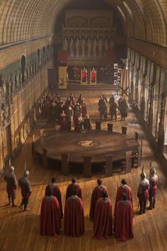 a group of people standing in a large room with wooden floors and arches on the ceiling