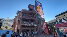 people are standing in front of the old red building at disney's hollywood studios