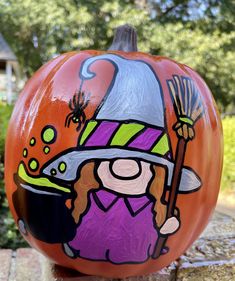 a painted pumpkin with a witch on it