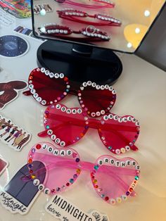 Hand decorated Jonas Brothers love heart glasses 💗 Colours available: Dark pink Purple Light pink Red Blue Black *personalisation available - please let me know what you'd like, can be lyrics, names or dates etc!  if you'd like certain colour gems only, please also let me know when ordering * if you're worried about the beads falling off the glasses - don't 🤣 (watch the video) Arms of the glasses may be stiff when opening but they will fully open with care 💗MESSAGE ME FOR REQUESTS💗 If you wo Heart Glasses Decorated, Diy Heart Glasses, Decorated Heart Glasses, Bead Glasses Diy, Heart Glasses With Beads, Bedazzled Glasses, Love Heart Glasses, Sweet Sixteen Party Themes, Festival Glasses