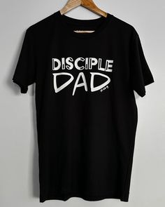 Father's Day Perfect Gift - Get yours now! Our Disciple Dad Tee is made with high-quality cotton to provide a soft and comfortable fit. The shirt is printed with Deuteronomy 6:6-9, the perfect reminder for fathers to continue teaching their children and passing down their faith. With its classic style and long-lasting durability, this tee is a great way to help dads impart the wisdom of the Bible to the next generation. These commandments I give you today are to be on your hearts. Impress them o Deuteronomy 6, Faith Tees, Cool Fathers Day Gifts, Christian T Shirts, Clothing Designs, The Wisdom, Good Good Father, The Next Generation, Gift For Dad