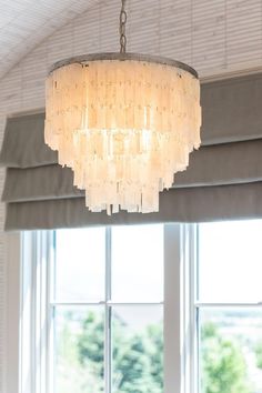 a chandelier hanging over a dining room table