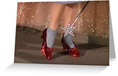 a woman's feet in red shoes with snowflakes on the toes