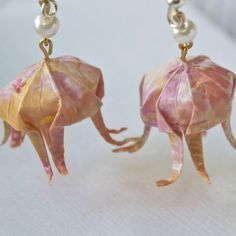 two origami elephants with pearls on their earwires are hanging from gold - plated hooks