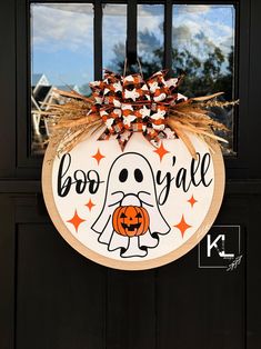 a halloween door hanger with a boo y'all on it and a pumpkin