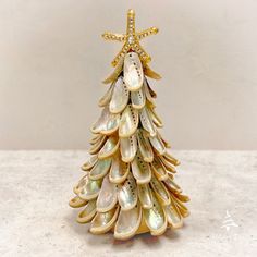 a small christmas tree made out of seashells