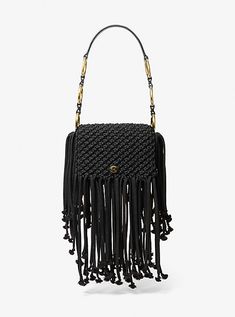 a black handbag with fringes on it