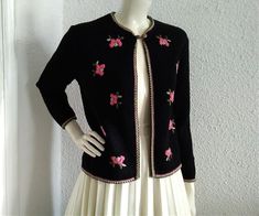 60s embroidered cardigan, elegant black sweater, pink floral embroidery, cropped wool spring jacket, folk rustic style cardigan, feminine romantic cardigan. ,, reine schurnwolle " writed on label means pure new wool. The cardigan is not washed or dry clean. vintage items always show signs of being worn measurements laying flat : shoulders :40 cm (15,5 inches) bust:48 cm (19 inches) total lenght :52 cm (20,5 inches) sleeve lenght :54 cm (21 inches) Elegant Embroidered Spring Sweater, Vintage Black Sweater For Spring, Black Vintage Sweater For Spring, Vintage Black Cardigan For Spring, Fitted Embroidered Pink Cardigan, Pink Embroidered Fitted Cardigan, Fitted Pink Embroidered Cardigan, Fitted Sweater With Floral Embroidery For Spring, Embroidery Cardigan