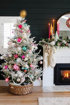 a decorated christmas tree in front of a fireplace