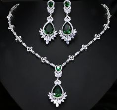 Not sold in Stores! Who doesn't love to dress up in their finest and flirt their style? This is perfect for an evening soiree, wedding, or party night. You'll come up with an occasion for sure! This Luxe Cubic Zirconia Necklace Earring Set - comes in a variety of simulated stones: Emerald Green/ Sapphire Blue or Wizard White. Make your evening cocktail dress or ball gown stand out even more. We know you'll wear it so well! Included Additional Item Description: * 1 pair Drop Earrings in your choice of 3 beautiful colors * 1 pc Necklace in your choice of 3 beautiful colors Earrings Length: 5.6 cm or 2-1/4" in. approx. Empress Drop Earrings Matching Choker Necklace: 43 cm or 17" in approx. Shop with confidence with our secure checkout: Apple Pay-Mastercard-Visa & PayPal FREE SHIPPING! Please Dazzling Hand Set Jewelry For Evening, Dazzling Hand Set Jewelry Sets For Evening, Dazzling Hand-set Jewelry Sets For Evening, Glamorous Diamond Evening Jewelry Sets, Dazzling Evening Jewelry Sets Hand Set, Glamorous Evening Diamond Jewelry Sets, Party Jewelry Sets With Diamond Accents In Cubic Zirconia, Elegant Jeweled Wedding Earrings, Dazzling Bridal Necklace With Diamond Accents For Party