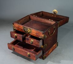 an old wooden box with three drawers