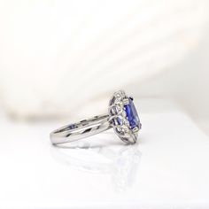 This beautiful ring features a 3.20 carat cushion cut Tanzanite gemstone with natural earth mined diamonds in solid 14K gold. This Tanzanite ring makes a lovely December birthstone gift for your loved ones! This ring is made with solid 14K Gold and natural Earth mined SI / G-H diamonds. As listed, this ring is ready to ship. If you're interested in purchasing this setting with a different center stone please message us! Luxury Sapphire Ring With Cushion Cut Center Stone, Luxury Cushion Cut Sapphire Ring With Center Stone, Elegant Tanzanite Birthstone Ring With Prong Setting, Cushion Cut Sapphire Ring With Cubic Zirconia Accent Stones, Sapphire Cushion Cut Cubic Zirconia Ring, Elegant Tanzanite Birthstone Ring With Center Stone, Cushion Cut Diamond Ring With Accent Stones In Platinum, Radiant Cut Sapphire Ring With Accent Stones, Cushion Cut Platinum Diamond Ring With Accent Stones