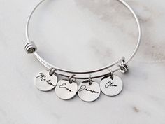 "Mama Bracelet / Name Bracelet / Personalized Charm Bracelet / Mothers Day Gift / Mum Gift for Her / Personalized Bangle Children's Names 13SS HOW TO ORDER 1) Select your number of charms and metal color 2) Select your font 3) Enter your details in the personalization box DESCRIPTION * Two sizes of bracelets available: Adult Medium 7-8\" wrist, Adult Small 5.5-6.5\" wrist * Stainless steel silver, electroplated gold and rose gold * Engraved in our studio with a laser engraver for precision * Han Personalized Charm Bangle Bracelet For Mother's Day, Personalized Bangle Charm Bracelet For Mother's Day, Engraved Charm Bracelet For Mother's Day Personalized Gift, Mother's Day Personalized Charm Bangle Bracelet, Personalized Mother's Day Bangle Charm Bracelet, Personalized Name Bracelet - Gift For Mom, Mother's Day Custom Name Charm Bracelet, Personalized Adjustable Name Bracelet For Mom, Personalized Bracelet As Gift For Mom