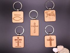 six wooden key chains with different designs and words on them, including the word faith