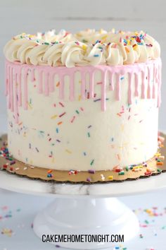 a birthday cake with white frosting and sprinkles