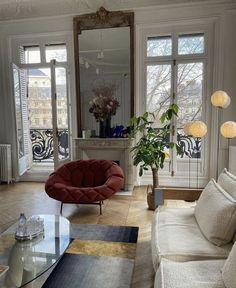 a living room filled with furniture and large windows