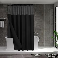 a black and white bathroom with a tub, shower curtain and toilet paper roll on the floor