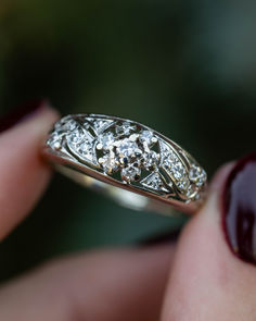 A close-up image showing an antique Art Deco era 14K white gold floral cluster diamond engagement ring. This ring features round diamond accents in a cluster that resembles a flower. Cluster Design, Staghead Designs, Diamond Cluster Engagement Ring, Cluster Engagement Ring, Antique Ring, Gold Art Deco, 1930s Art Deco, Antique Engagement Rings, Handcrafted Rings