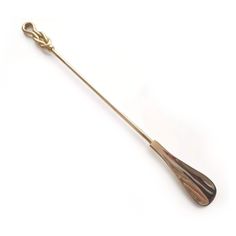 an antique gold - plated spoon with twisted handle