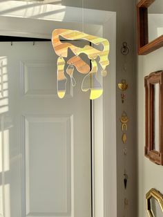 a light that is hanging from the side of a door with some decorations on it