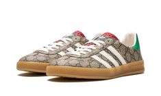 The Gucci x adidas Gazelle “Beige” is a limited edition collaboration by the legendary high fashion house on the popular lifestyle sneaker that features the brand’s iconic monogram pattern.  Gucci and adidas’s second collaboration brings a luxurious twist to the adidas Gazelle by placing the former’s “GG” monogram print in an all-over style on the shoe’s canvas upper.  The look is inspired by 1980s-era sportswear aesthetics.  Black leather Three Stripes branding can be found on either side of th Platform Shoes Outfits, Adidas Gucci Gazelle, Adidas Gazelle Beige, Gucci X Adidas, Adidas Gucci, Nike X Travis Scott, Toddler Adidas, Adidas Models, Nike Models