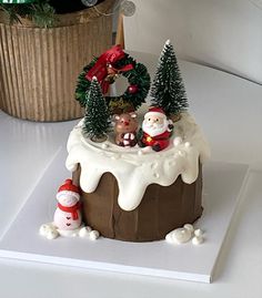 a small christmas cake with santa and other decorations