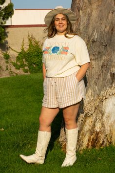 Part beach vibes and part country. Our Coastal Cowgirl Oversized tee is made from 100% US Ring Spun cotton. It's super soft with some stretched and just the right amount of oversized. The cute coastal cowgirl design is distressed and made here right in our shop. A true summer staple tee. Details: 100% US Ring Spun Cotton Sizes S-4XL. Oversized Fit. Shirt color may vary in different lightings Garment dyed for that lived in feel and almost no shrinkage at home. Topstitched, classic width, rib coll Casual Beige T-shirt For Day Out, Beige Summer T-shirt For Day Out, Beige T-shirt For Summer Day Out, Casual Cream T-shirt For Loungewear, Oversized Beige T-shirt For Summer, Beige T-shirt For Beach, Summer Season, Cowgirl Design, True Summer, Coastal Cowgirl