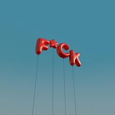 the letters f c k are suspended by strings in front of a clear blue sky