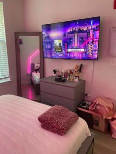 a bed room with a neatly made bed and a flat screen tv on the wall