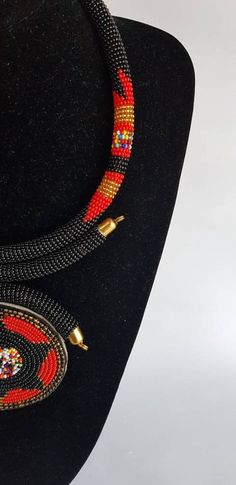 100% handcrafted using fine beads. The necklace makes a perfect gift. This necklace is approximately 17 inches long and 4 inches pendant. **Buy multiple items and pay shipping for 1 item only.The rest ships free. More neckleces here; https://www.etsy.com/shop/TribalTess?ref=seller-platform-mcnav&section_id=21306083 Back to my shop; https://www.etsy.com/shop/TribalTess?ref=seller-platform-mcnav Gift Beaded Necklace With Large Beads And Round Pendant, Handmade Red Beaded Necklaces With Round Pendant, Unique Black Beads For Gifts, Unique Black Beaded Necklaces As Gift, Handmade Red Beaded Necklace With Round Pendant, Handmade Black Beaded Necklace With Round Pendant, Unique Black Beaded Necklaces For Gifts, Gift Black Beads Pendant Necklace, Gift Black Beaded Pendant Necklace