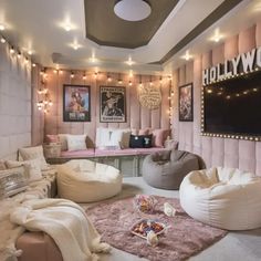 a living room filled with lots of furniture and lights on the wall above it's windows