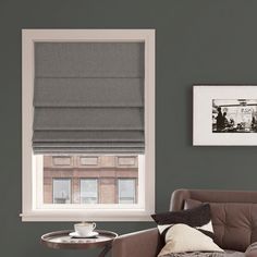 a living room with a couch, chair and coffee table in front of a window