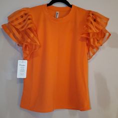 New Organza Women's Blouse Size: Xl Color: Orange ** New ** Comment If You Have Any Questions Or Would Like To See More Pictures. Bundle And Save Reasonable Offers Accepted Casual Orange Blouse For Party, Casual Orange Party Blouse, Chic Orange Short Sleeve Top, Chic Orange Blouse With Ruffles, Casual Orange Top With 3/4 Sleeves, Orange V-neck Blouse With Ruffles, Casual Orange Moisture-wicking Tops, Orange Cotton Button-up Blouse, Flowing Blouse