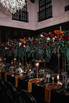 an instagram photo with flowers and candles on the table in front of it is shown