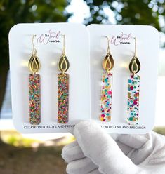 Birthday Candle long earrings make for a unique gift or a treat to yourself, embodying the spirit of celebration and joy. Whether it's a milestone birthday or a simple celebration, these earrings are a delightful way to commemorate special moments. Crafted from premium acrylic glitter, mirror acrylic, and stainless steel, these earrings offer a lightweight yet durable design. Their dimensions, measuring at 2.7" from hook and 0.5" wide, ensure a perfect balance of statement and subtlety. Experien Trendy Earrings For Anniversary And Mother's Day, Trendy Dangle Jewelry For Birthday, Trendy Earrings For Mother's Day Gift, Gold Earrings For Mother's Day Party, Birthday Drop Earrings, Party Earrings For Mother's Day, Handmade Jewelry For Party Gifts, Handmade Jewelry For Parties And Gifts, Handmade Jewelry For Party And Gift-giving Occasions