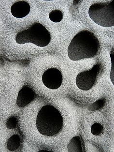 several holes in the sand that look like they are made out of cement