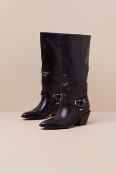 Create signature looks all season long with the help of the Lulus Assia Black Slip-On Knee-High Moto Boots! Super smooth faux leather shapes these slip-on boots with a pointed-toe upper that rises to a 13"" knee-high shaft with a 14.75"" circumference. Three matching studded straps come together at the outstep and instep via a shiny silver O-ring for a moto-inspired effect. A stacked block heel completes the look! 2. 5" stacked block heel. Cushioned insole. Rubbed sole has nonskid markings. Man Wide Calf High Ankle Moto Boots For Fall, Fall Knee-high Moto Boots Medium Width, Fall Medium Width Knee-high Moto Boots, Edgy Wide Calf Knee-high Boots For Winter, Edgy Wide Calf Platform Boots For Fall, Fall Wide Calf Pointed Toe Knee-high Boots, Wide Calf Mid-calf Boots With Buckle For Fall, Trendy Mid-calf Leather Boots, Edgy Knee-high Moto Boots For Fall