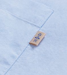 a blue shirt with a wooden clip on it