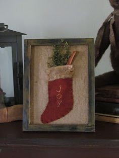 a christmas stocking hanging on a shelf next to a lantern