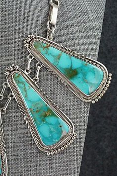 This vintage and intricately crafted Turquoise Mountain turquoise and sterling silver necklace, earrings, bracelet and ring set was made by Navajo silversmith Oliver Smith. The set is signed O. Smith and stamped .925.Necklace: 18"Length: 2 5/8"Width: 1 1/8"Earrings:Length: 1 3/8"Width: 3/4"Ring:Size: 10.5Length: 1 1/4"Width: 1"Bracelet:Size: 5 1/4" (fit for a 6 3/4" wrist)Gap: 1 1/2"Length: 1 3/4"Free shipping on all orders! We ship with USPS and always include tracking. All orders ship within a Southwestern Style Jewelry In Sterling Silver Stamped 925, Southwestern Style Jewelry In Sterling Silver, Southwestern Sterling Silver Jewelry Stamped 925, Collectible Turquoise Sterling Silver Necklace, Artisan Untreated Jewelry For Collectors, Southwestern Sterling Silver Gemstone Jewelry, Bohemian Sterling Silver Jewelry Untreated, Bohemian Untreated Sterling Silver Jewelry, Untreated Bohemian Sterling Silver Jewelry