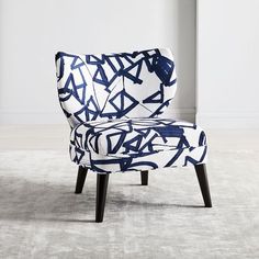 a blue and white chair sitting on top of a carpet