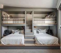 two beds in a room with stairs leading to the top floor and bottom bunk bed