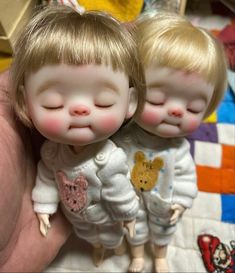 two little dolls that are laying down together